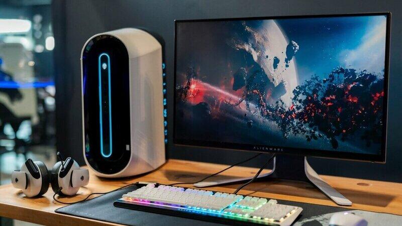 Electric standing desk with dual monitors in a home office